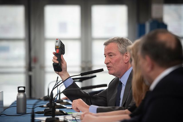 Mayor Bill de Blasio holds up a lead paint detector at a news conference on April 19th, 2020. The detectors would test 135,000 NYCHA units amid a lead paint scandal that engulfed NYCHA and de Blasio.